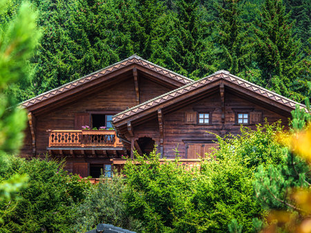 Alpine Swiss Village. Comfort and tranquility. A sunny summer day. Flowers on the windows. Wooden chalets.の写真素材