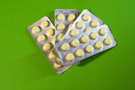 plates with pills on a green backgroundの写真素材
