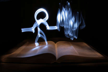 light man and fire from hand, and bookの写真素材