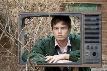 serious man in old tv box, on streetの写真素材