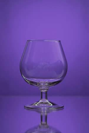 glass on a mirror and reflection purple backgroundの写真素材