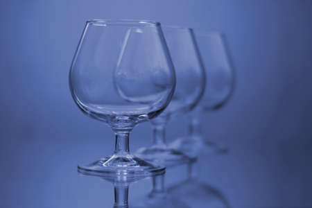 glass on a mirror and reflection blue backgroundの写真素材