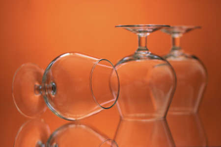 glass on a mirror and reflection orange backgroundの写真素材