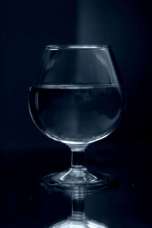 glass on a mirror and reflection black backgroundの写真素材