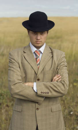 Young man wearing black hat and golden suitの写真素材