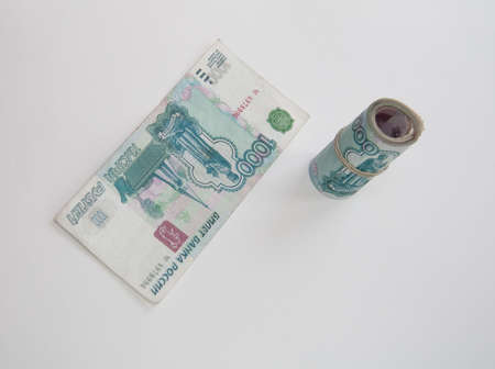 Roll rubles on light background with 1000 bank noteの写真素材