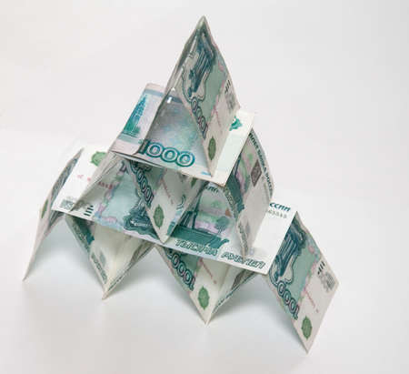 Money pyramid isolated on light backgroundの写真素材