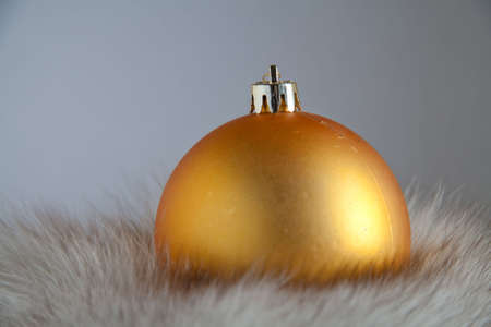 Christmas ball resting on white fur and place for textの写真素材