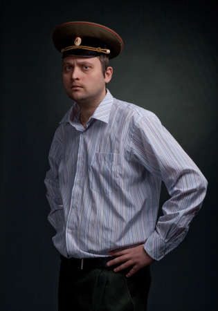 Serious man in hat and suit studio shot dark background.