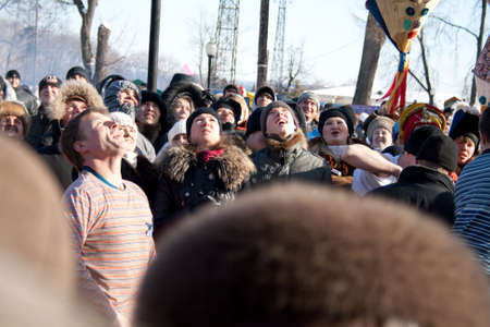 PENZA, RUSSIA - February 14. Celebration of Shrovetide (Maslenitsa) in russian citycrowd see to the man which try to climb up a column (russian entertainment)のeditorial素材