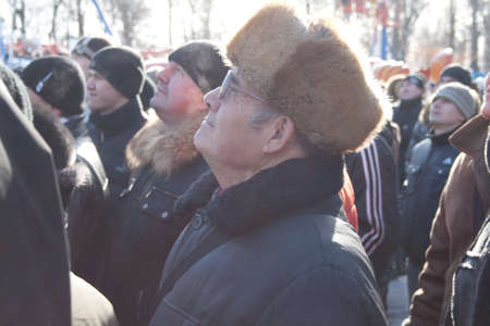 PENZA, RUSSIA - February 14. Celebration of Shrovetide (Maslenitsa) in russian citycrowd see to the man which try to climb up a column (russian entertainment)のeditorial素材