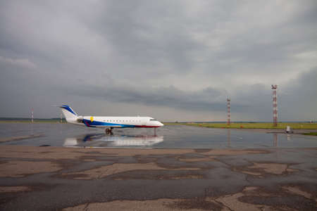Private aircraft on airport runway Stormy cloudsの写真素材