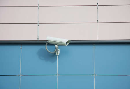 security camera on a wall of an office buildingの写真素材