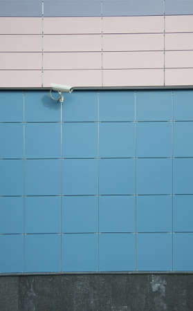 security camera on a wall of an office buildingの写真素材