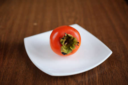 persimmon on a white plateの写真素材