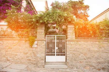 White Metallic Door on a Typical Old Stone Building in Sardinia. Italy.の写真素材