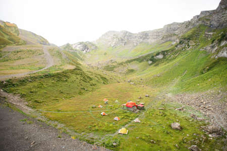 Mountains with Alpine Meadows in Sochi. Krasnaya Polyana. Russia. Base Camp in the Valley.の写真素材