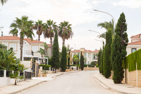 Protaras. Cyprus - October 5, 2018: Street with Villas and Cypresses in Protaras.のeditorial素材
