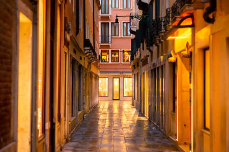 Venice. Italy - May 13, 2019: Calle Vallaresso Street in Venice. Italy. Early Morning. Store of Omega Company. Beautiful Golden Lights.のeditorial素材