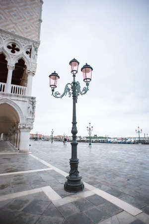 Old Street Lantern in Venice on San Marco Square. Early Rainy Morning. Cloudy Sky.の写真素材