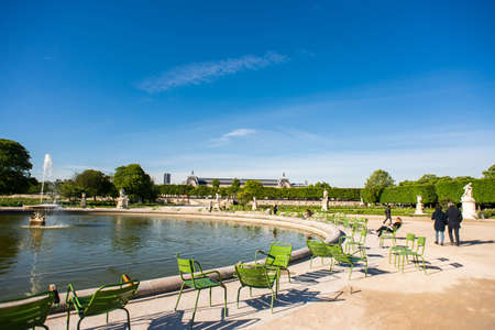 Paris. France - May 15, 2019: People Sits and Relaxing on a Chairs next Fountain in Tuileries Garden.のeditorial素材