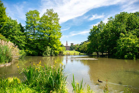 Milan. Italy - May 21, 2019: Pond in Sempione Park (Parco Sempione) in Milan, Italy. Sforza Castle (Castello Sforzesco) on Background.のeditorial素材