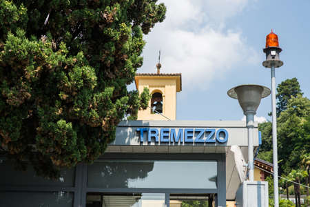 Tremezzo. Lake Como. Italy - July 19, 2019: Ferry Pier in the Commune of Tremezzo. Lombardy. Signboard with Name of the City.のeditorial素材