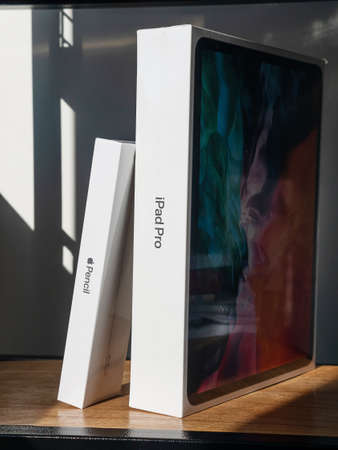 Penza. Russia - August 20, 2020: Packed Apple iPad Pro 2020 and Apple Pencil. Diagonal 12.9 Inches. Tablet Computer on a Wooden Shelf.のeditorial素材