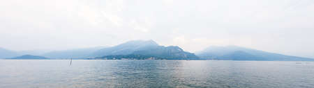 Picturesque Landscape on Lake Como with Alps on Background. Italy. Panoramic View. A Magical Panoramic Landscape.の写真素材