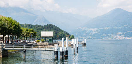 Lake Como. Italy - July 21, 2019: Ferry Pier of Colico City. Lake Como in Italy. Alps on Background.のeditorial素材