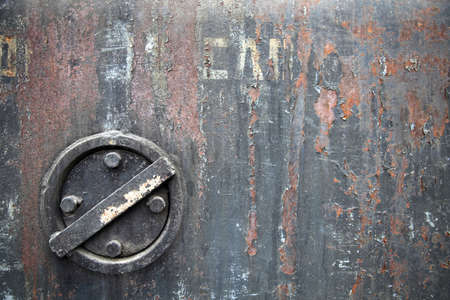 Rusty iron background with valve  With the remains of the inscription   flammable    Is not a trademark の写真素材