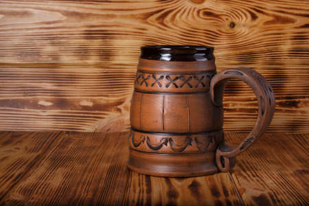 ceramic beer mug on wooden backgroundの写真素材