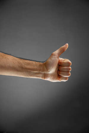 hand on a gray background. gesture of approval or disapprovalの写真素材