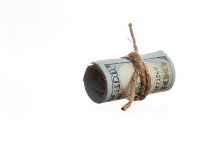 Rolled American dollars banknotes on a white backgrondの写真素材