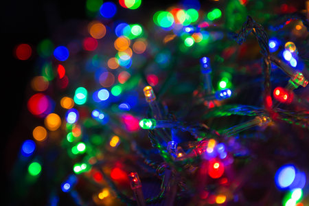 LED electric Christmas lights on wooden background