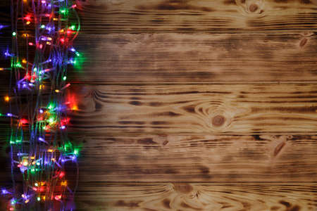 Christmas rustic background - vintage planked wood with lights and free text spaceの写真素材