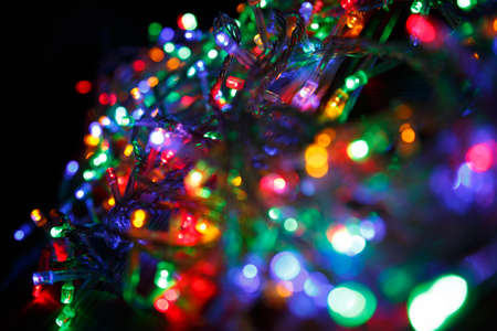 LED electric Christmas lights on wooden backgroundの写真素材