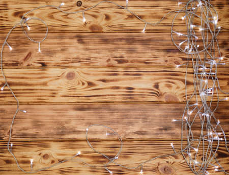 Christmas lights on wooden backgroundの写真素材