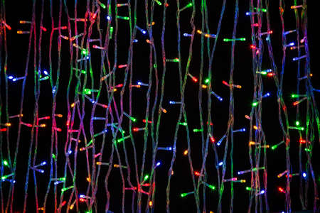 LED electric Christmas lights on dark backgroundの写真素材