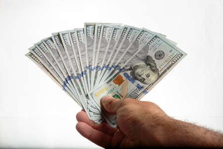 Hand with money isolated on a white backgroundの写真素材