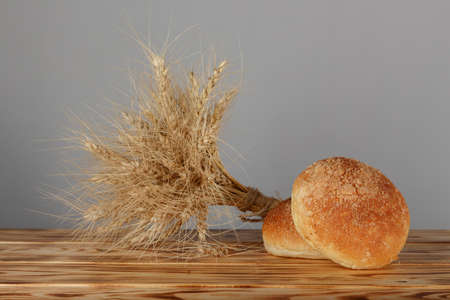 fresh bread and wheat on the wooden. neutral gray backgroundの写真素材