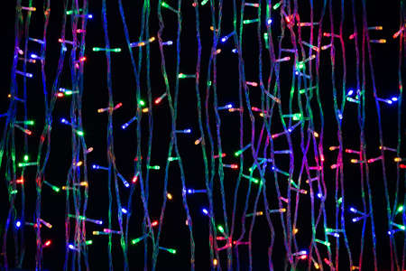 LED electric Christmas lights on dark backgroundの写真素材