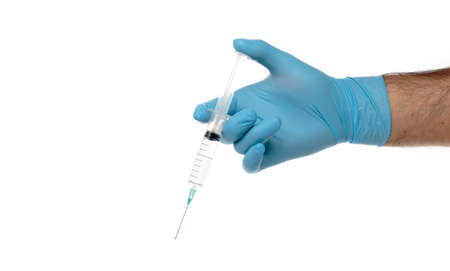 Man's gloved hand with a syringe with clear liquid isolated on whiteの写真素材