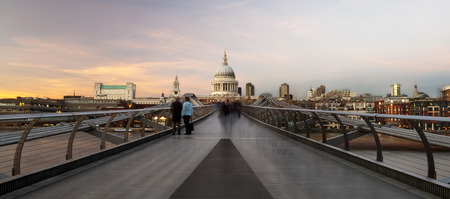 Commuters crossing the Millenium Bridge walking towards St Pauls Cathedralの写真素材