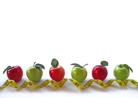 Row of apples with tape measureの写真素材