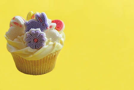 Easter bunny cupcakes on a yellow backgroundの写真素材