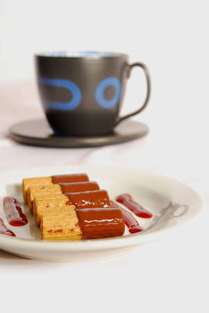 black coffee cup with cookies over white backgroundの写真素材