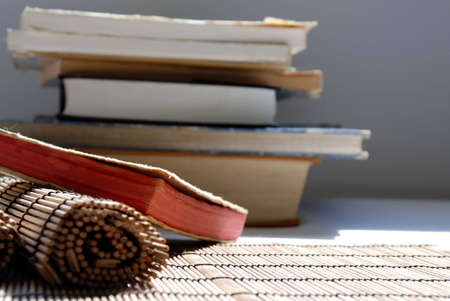 wattled wood placemat with old booksの写真素材