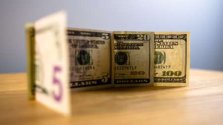10 20 100 dollars are on the table, side view, the watermark on the banknote is seen throughの写真素材