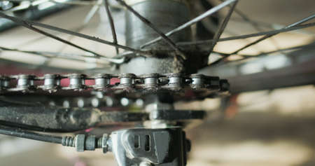 bicycle chain rotates the rear wheel of the bicycle, the sprocket is spinning, close-up. Top view of...